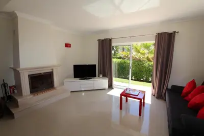 a living room with a tv and a fireplace at Modern Vilamoura Villa Close To Pinhal Golf Villa Maelou 4 Bedrooms in Quarteira