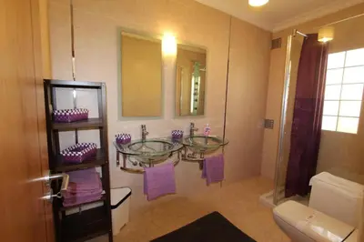 a bathroom with two glass sinks and a shower at Modern Vilamoura Villa Close To Pinhal Golf Villa Maelou 4 Bedrooms in Quarteira