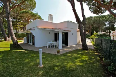 a white house with a table in a yard at Contemporary Portuguese Villa 4 Bedrooms Villa Violeta Private Pool in Quarteira