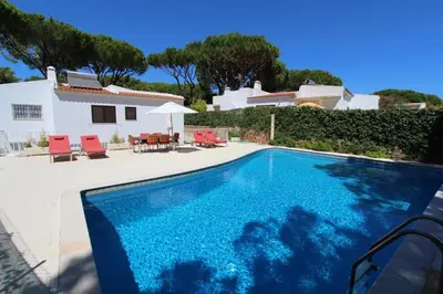 a swimming pool in front of a house at Contemporary Portuguese Villa 4 Bedrooms Villa Violeta Private Pool in Quarteira