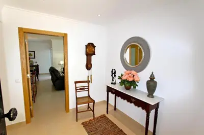 a room with a table and a mirror and a chair at Contemporary Portuguese Villa 4 Bedrooms Villa Violeta Private Pool in Quarteira