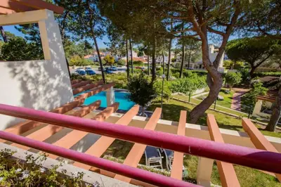 a view of a pool from the balcony of a resort at Beach House (Golf) - Falésia/Albufeira in Albufeira