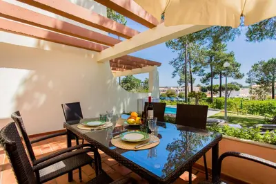 a dining room with a table and chairs at Beach House (Golf) - Falésia/Albufeira in Albufeira