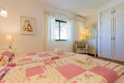 a large bedroom with two beds and a dresser at Beach House (Golf) - Falésia/Albufeira in Albufeira