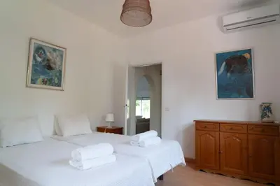 two beds in a room with white walls at Beautiful private Villa with pool, Boliqueime, Loulé in Boliqueime