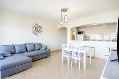 a living room with a couch and a table at Albufeira Holidays Near The Strip in Albufeira