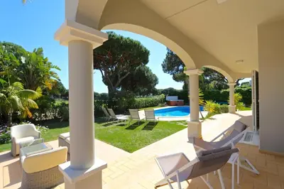a patio with chairs and a swimming pool at Luxury Vilamoura Villa 4 Bedrooms Villa Corvo Billiards in Quarteira