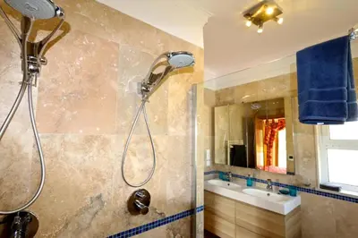 a bathroom with a shower with a blue towel at Luxury Vilamoura Villa 4 Bedrooms Villa Corvo Billiards in Quarteira