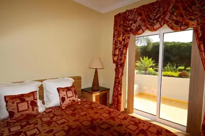 a bedroom with a bed and a large window at Luxury Vilamoura Villa 4 Bedrooms Villa Corvo Billiards in Quarteira
