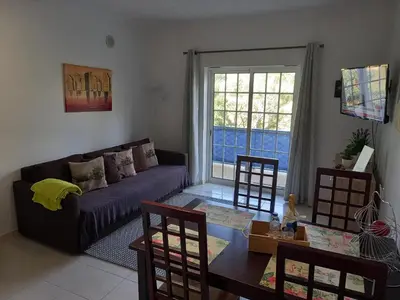 a living room with a couch and a table at Flamingos Apartment with 2 swimming pool com check in e check out ao domingo em julho e agosto in Albufeira