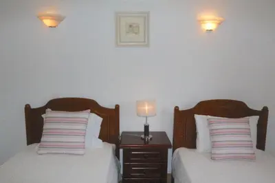 a bedroom with two beds and a nightstand with two lamps at Traditional Portuguese Villa 5 Bedrooms Villa Girassol Prime Location in Quarteira