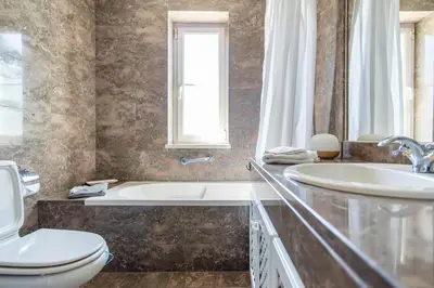 a bedroom with a bed with two towels on it at Charmante villa Authentique in Loulé