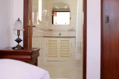 a bathroom with a sink and a mirror at Villa Da Duarte - walkable to beach shops bars in Albufeira