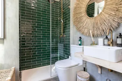 a bathroom with a toilet and a sink and a mirror at @ rita'splace in Faro