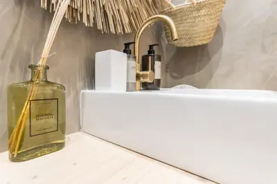 a bathroom with a sink and a bottle on a counter at @ rita'splace in Faro