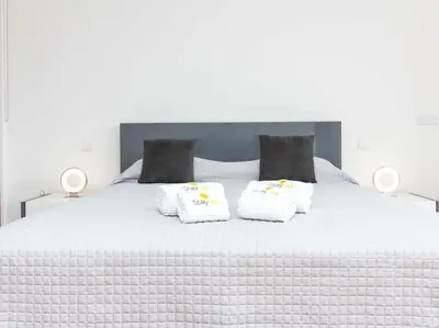 a white bed with two pillows on top of it at Harmony 4B House by Stay ici Algarve Holiday Rental in Albufeira