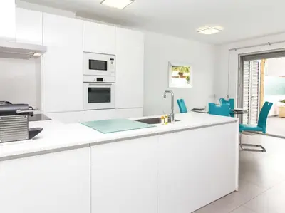 a white kitchen with a sink and a stove at Harmony 4B House by Stay ici Algarve Holiday Rental in Albufeira