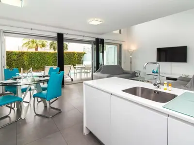 a kitchen and living room with a table and chairs at Harmony 4B House by Stay ici Algarve Holiday Rental in Albufeira