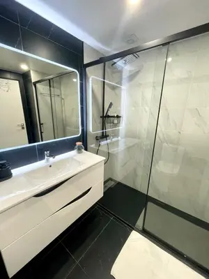 a bathroom with a sink and a glass shower at Apart 306 in Albufeira