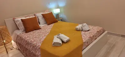 a bedroom with a large bed with towels on it at endless summer-with pool in Albufeira