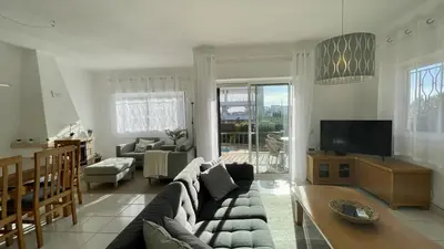 a living room with a couch and a tv at Margarida by Check-in Portugal in Albufeira