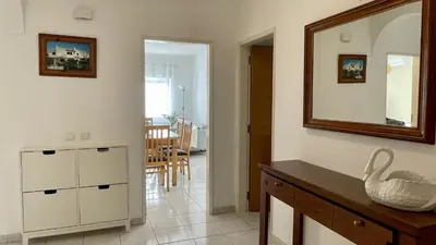 a living room with a sink and a mirror at Margarida by Check-in Portugal in Albufeira