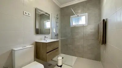 a bathroom with a toilet and a sink and a mirror at Margarida by Check-in Portugal in Albufeira