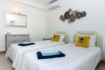 two beds with towels on them in a bedroom at Bay View Modern Apartment in Albufeira