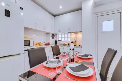 a dining room with a red table and chairs at Faro: Casa Trevo com terraço BBQ in Faro