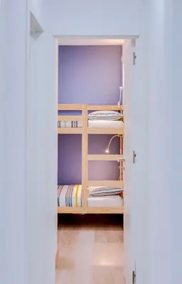 a closet with bunk beds in a room at Faro: Casa Trevo com terraço BBQ in Faro