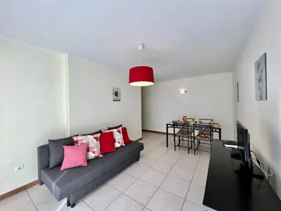 a living room with a couch and a table at Albufeira Brightness by Homing in Albufeira