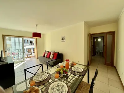 a living room with a glass table with food on it at Albufeira Brightness by Homing in Albufeira