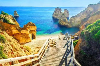 a staircase leading to a beach near the ocean at AlbufeiraOrada II by Be Cherish in Albufeira