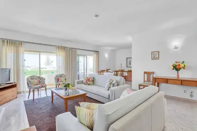 a living room with a couch and a table and a tv at Isabel Vivenda in Patroves