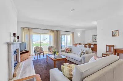 a living room with white furniture and a fireplace at Isabel Vivenda in Patroves