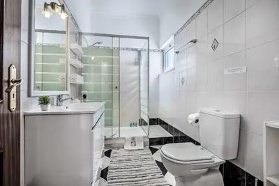 a bathroom with a toilet and a sink and a shower at Villa Dois Pinheiros in Albufeira