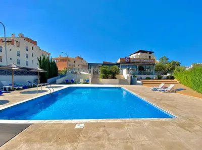 a large swimming pool in the middle of a building at Corcovada, Sunny and Bright T1 with Large Terrace, Albufeira in Albufeira