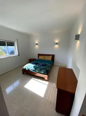 a dining table and chairs in a living room at Apartamento Mimosas in Albufeira