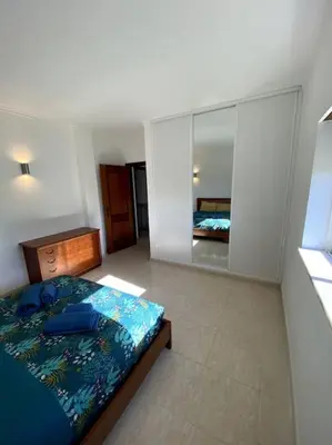 a kitchen with a table and some chairs in it at Apartamento Mimosas in Albufeira