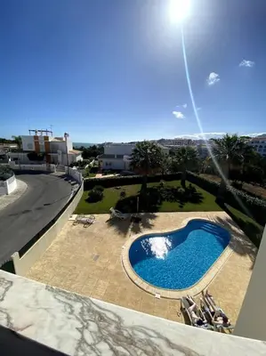a view of a swimming pool from a balcony at Apartamento Mimosas in Albufeira