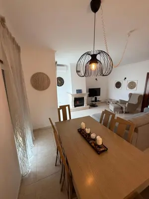 a living room with a couch and a tv at Apartamento Mimosas in Albufeira