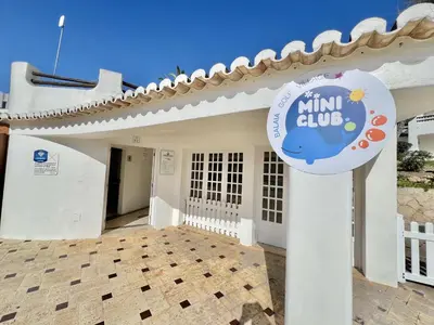 a white house with a sign in front of it at Albufeira Balaia Golf Vilage 1 With Pool by Homing in Albufeira