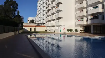 a swimming pool in the middle of a building at Visconde By Albufeira Rental in Albufeira