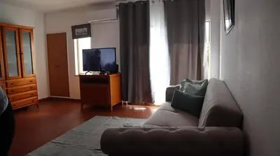 a living room with a couch and a television at Visconde By Albufeira Rental in Albufeira