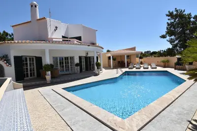a villa with a swimming pool in front of a house at Villa Casa Tulipa Sleeps 4 with Pool Garden & A c in Albufeira