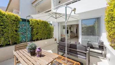 a patio with a table and chairs and an umbrella at Keiko in Vale do Lobo