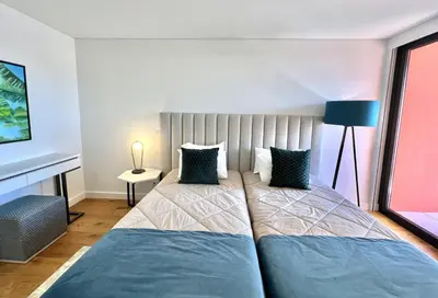 a bedroom with two beds and a window at One - Luxurious apartment by HD PROPERTIES in Vilamoura