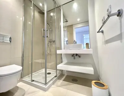 a bathroom with a shower and a toilet and a sink at One - Luxurious apartment by HD PROPERTIES in Vilamoura