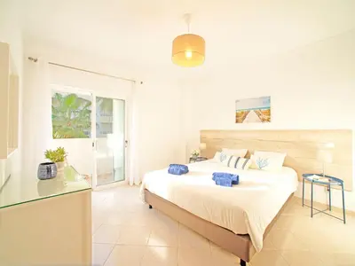 a white bedroom with a bed and a table at Villa Inês by Interhome in Galé