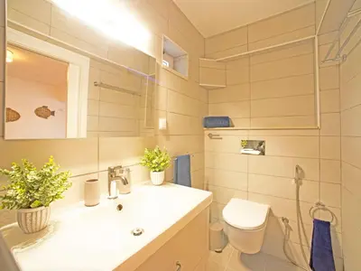 a bathroom with a sink and a toilet and a mirror at Villa Inês by Interhome in Galé